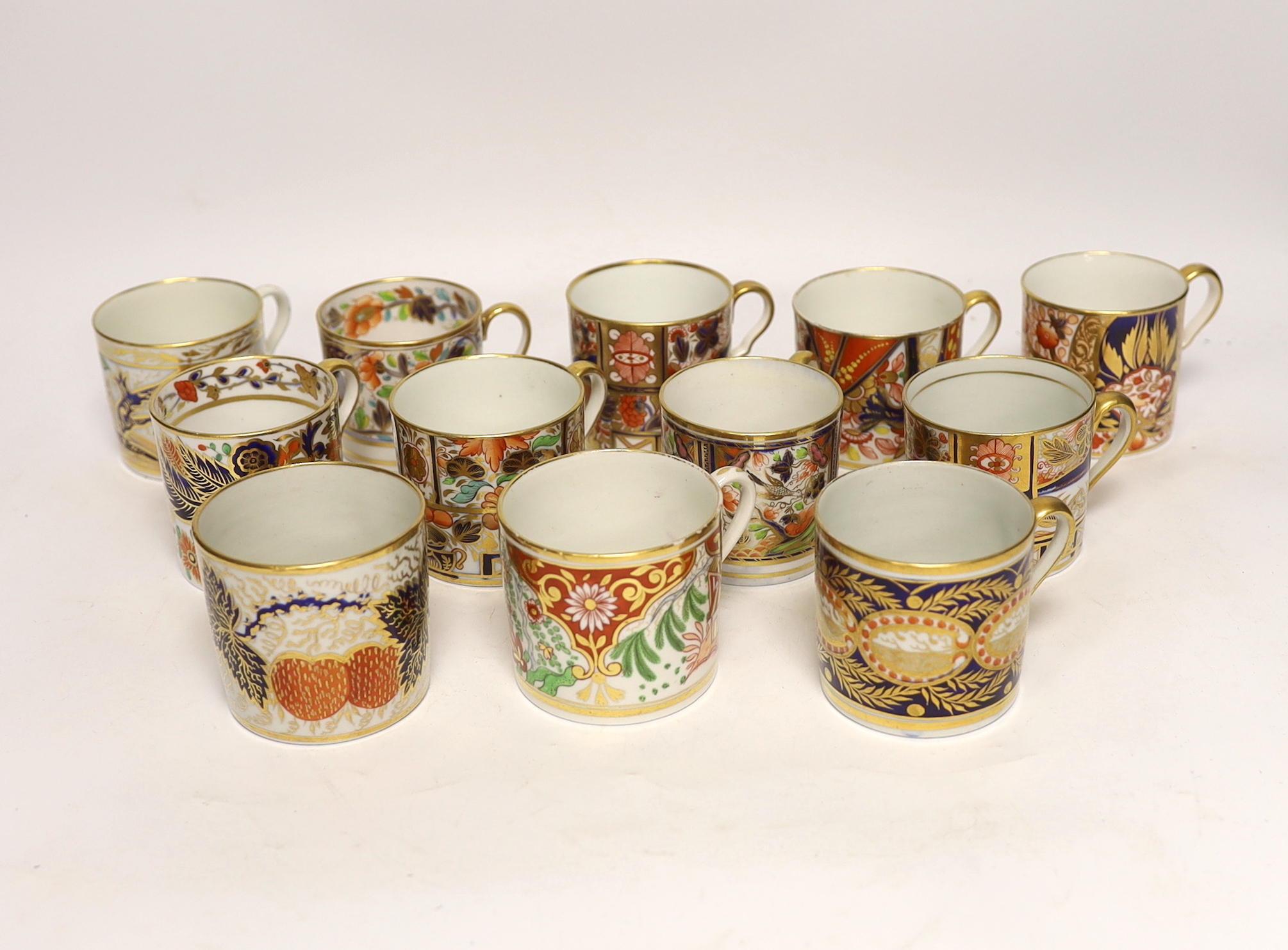 Twelve 1800-1820 English Imari style patterned coffee cans